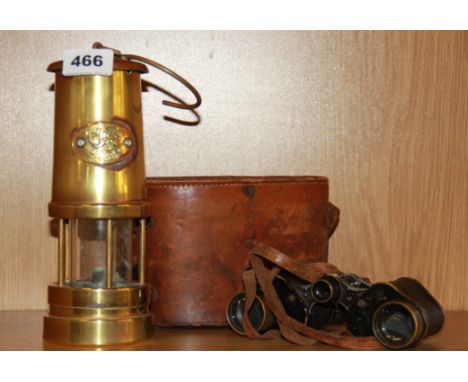 A Welsh minor's lamp and a pair of World War Two military binoculars by Bausch &amp; Lomb, USA.