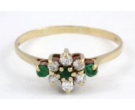 A 9ct yellow gold emerald and white stone set cluster ring, (R.5).