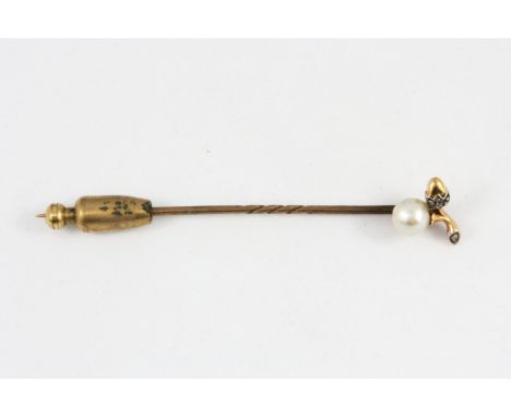 A yellow metal (tested 9ct gold) pearl and diamond set stick pin in an antique box.