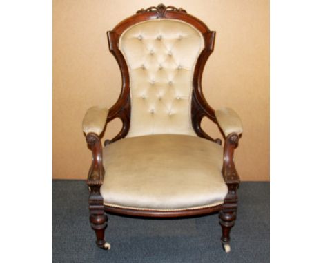 A 19th Century carved mahogany button backed armchair.