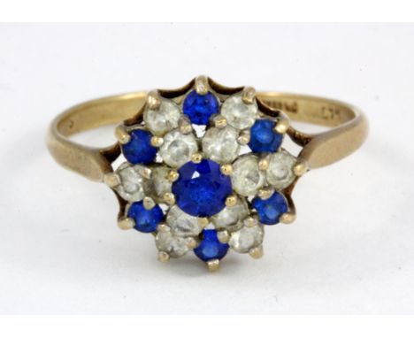 A 9ct yellow gold stone set cluster ring, (R.5).