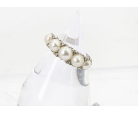 An Edwardian platinum and five pearl ring, the scroll sided tablet graduated half cut pearls and heightened by rose cut diamo