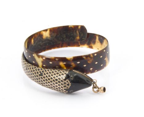 A good Victorian tortoiseshell pique work serpant bangle, the coiled snake having applied diamond shaped gold inlay to body a