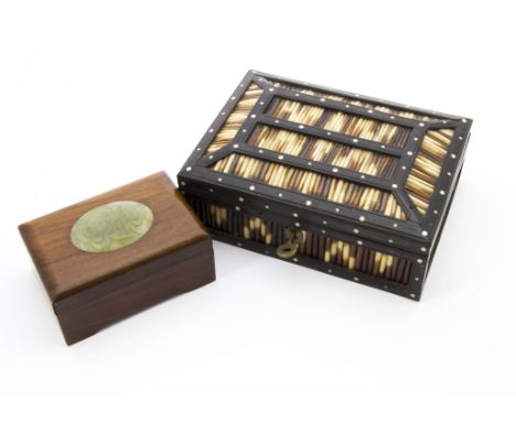 An early 20th century ebony and quill casket box, inlaid with porcupine quills and opening to reveal panel marked Ceylon, tog