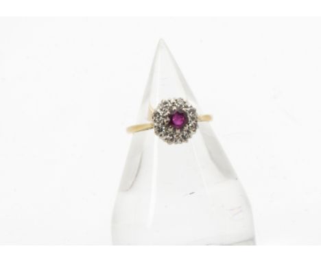 A 1960s 18ct gold ruby and diamond cluster ring, platinum claws supporting circular red stone and 8 eight cuts, 2.7g and size