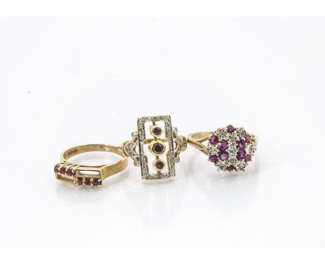 Three gold and gem set rings, one Art Deco style set with three red stones and clear stones, another cluster in 9ct gold and 