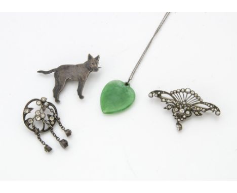 An early 20th century silver and niello enamelled dog brooch, together with a green harsdstone pendant on chain, possibly jad