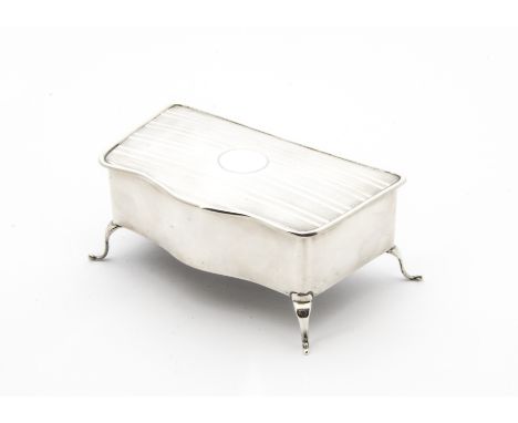 A George V silver jewellery casket, with serpentine front on four scroll supports, engine turned stripes to hinged lid openin