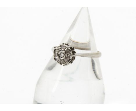 A 1960s 18ct white gold and diamond cluster ring, the circular tablet set with seven rose cuts, marked 750, 3.5g and size S 