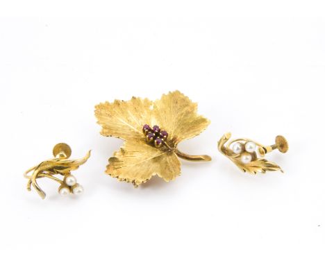 A 1960s 18ct gold and ruby leaf shaped brooch, 6.9g, together with a pair of 9ct gold and seed pearl leaf and berry earrings,