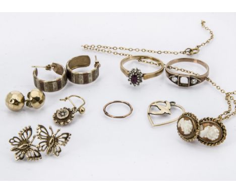 A small group of gold and other jewellery, including a 9ct gold and ruby and CZ ring, an unmarked gold ring with two white sa