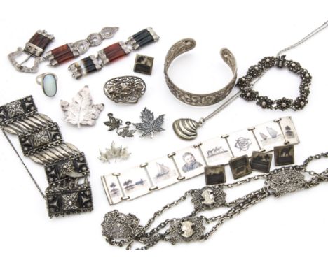 A collection of of silver and white metal items of jewellery, including a cuff bangle, a belt, a Middle Eastern niello panel 