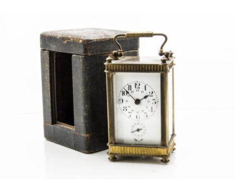 An Edwardian period brass carriage time piece, presented in a travel case, the clock having enamel dial, case tatty and some 