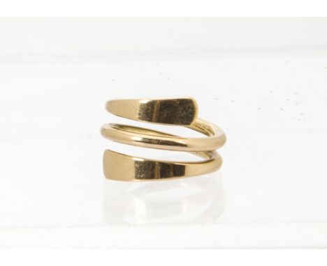 A continental yellow metal dress ring, in the form of a spiral with flared terminals, marked 18k, 10g 