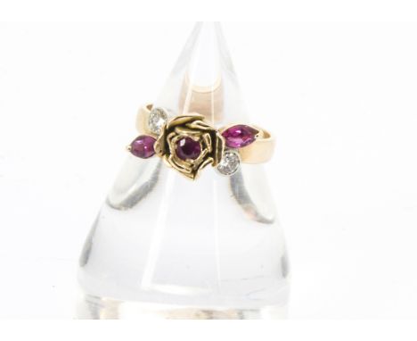 A pretty gold ruby and diamond ring, having rose to centre, and set with three red stones and a pair of brilliant cuts, 4.8g 