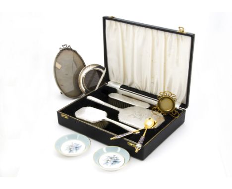 A George VI period cased silver dressing table set, together with a small circular silver photograph frame, two further frame