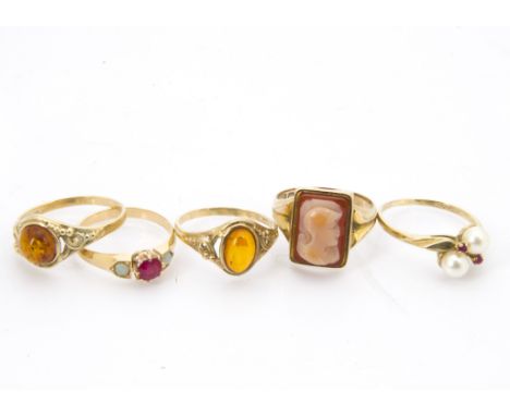 Five gold rings, including an 18ct gold, ruby and opal three stone, two 9ct gold and amber examples, a 9ct gold and cameo sig