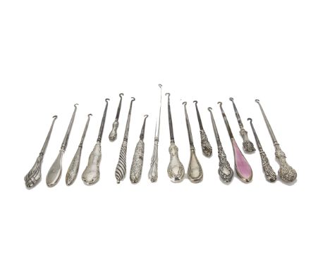 A collection of 16 Victorian and later silver handled button hooks, including one with pink guilloche enamel, and others of v