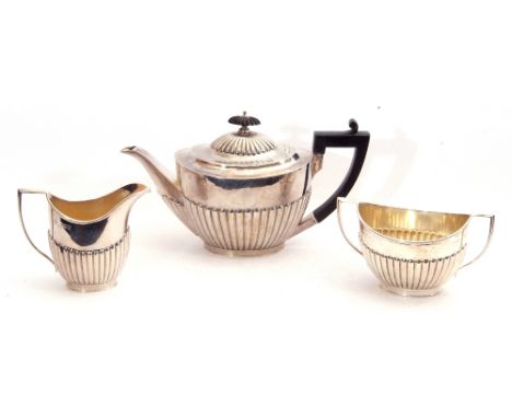 Silver three-piece bachelor's tea service of oval form comprising tea pot, twin handled sugar bowl and cream jug, each with h