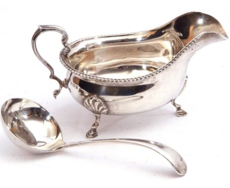 Mixed Lot: George V silver sauce boat of typical form, gadrooned rim with capped scroll handle, supported on three hoof feet,
