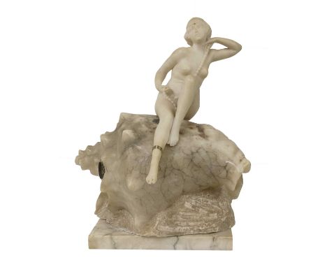 Ernst Seger (German, 1868-1939),an Art Deco carved alabaster figural table lamp, in the form of a nude female seated on a con