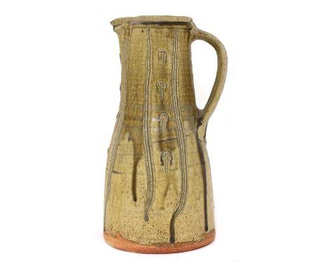 *Jim Malone (b.1946),a stoneware jug, of tapering form with a trailing green/brown glaze, with combed details, impressed arti