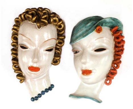 Two Goldscheider pottery wall masks, No. 6427, modelled as a lady with gold curling hair, orange lips, pierced eyes and with 