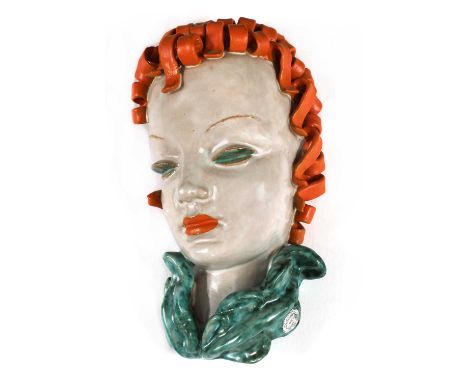 A Goldscheider pottery wall mask, No. 6775, modelled as a lady with curly orange hair and lips, green eyelids, and a turquois
