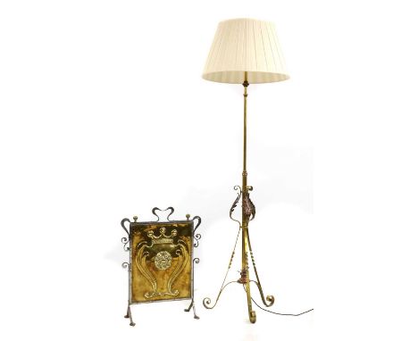 A brass standard lamp,in the manner of W A S Benson, with three scrolled supports with acanthus leaf detail, with a pleated s