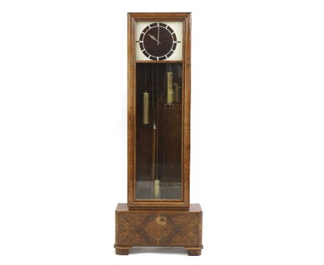 An Art Deco walnut longcase clock,the square painted and pierced dial with a Bakelite face, a three-train movement, in a cush