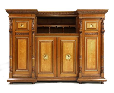 A walnut and maple compactum,c.1880, the inverted top with a carved frieze, over a felt-backed shelf and fleur-de-lys cut apr