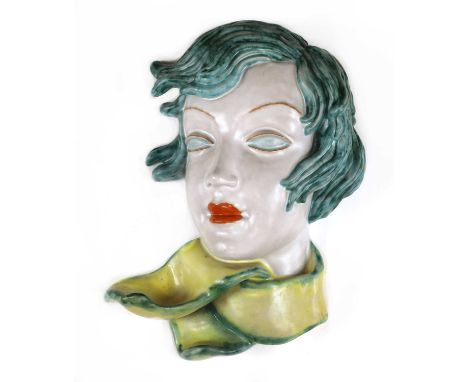 A Goldscheider pottery wall mask,No. 7089/65, with windswept turquoise hair and eyes, orange lips, a yellow scarf with turquo