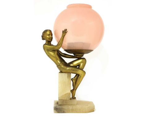 An Art Deco gilt metal figural table lamp,modelled as a seated lady holding a pink glass globe, on an onyx plinth,36cm highCo