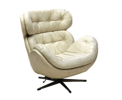 A white leather armchair, 1970s, white leather button back seat, raised on a revolving stand, 87cm wide85cm deep91cm high, se