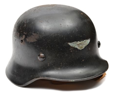 A German M40 style steel helmet, the skull with smooth black finish, 3 large domed rivet heads and no maker’s marks, the fron