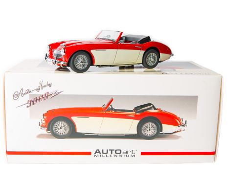 A 1:18 scale Autoart Millennium series Austin Healey 3000. An example in red and cream with wire wheels, black/red interior, 