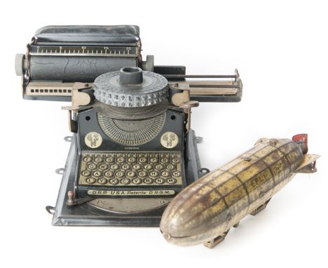 2 German tinplate toys. A 1920’s child’s typewriter by GSN (Gebruder Schmidt Nurnberg). A Junior Model 3 with two level disc 