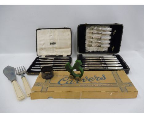A cased set of six MOP handled fish eaters, a cased set of six silver handled knives and an unusual green perspex napkin ring