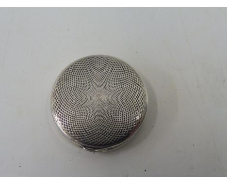 A small circular silver pill pot with good quality engine turned decoration.