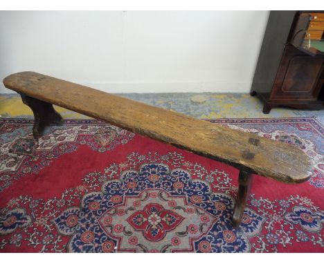 An 18th Century West Country figured elm primitive slab top farm house bench of good colour. 
