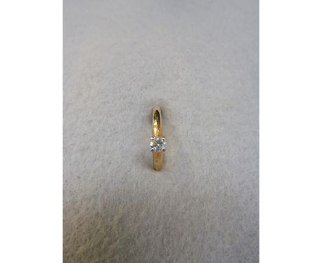 A 14ct gold ring set with a diamond. 