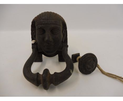 An unusual cast metal door knocker of Egyptian influence.