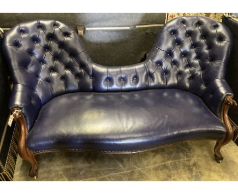 A Victorian mahogany double spoon back settee upholstered in dark blue button leather, width 180cm, depth 180cm, height 95cm