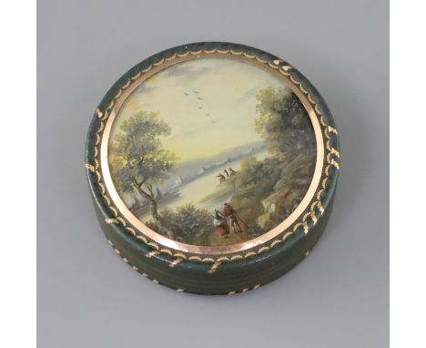 An early 19th century French bois durci snuff box, with gold inlaid decoration, the lid inset with a reverse painted glass pa