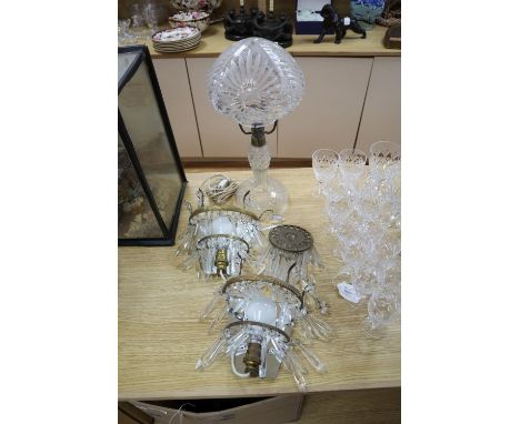 A cut glass table lamp, height 44cm and a pair of lustre wall lights