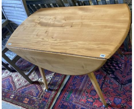 An Ercol light elm and beech circular drop leaf dining table, width 110cm, depth 127cm extended