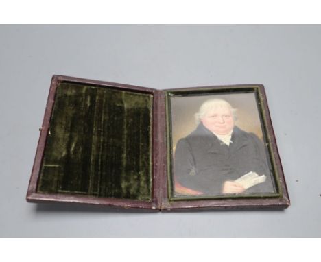 A mid 19th century portrait miniature of a seated gentleman, in folding frame, height 11cm