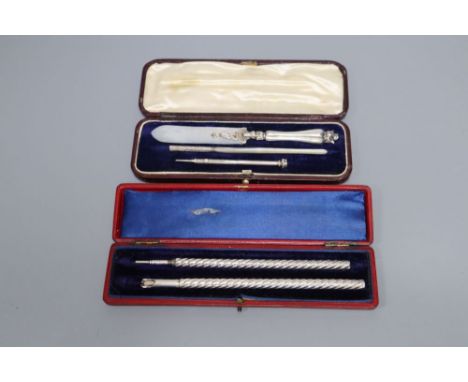 A cased late Victorian silver spiral decorated pen and a similar sterling pencil, 15.2cm and a cased white metal pen, pencil 