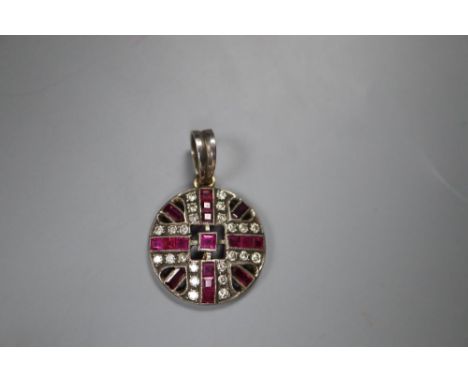 An early 20th century white and yellow metal, ruby and diamond set pierced circular pendant, 20mm, gross 3.7 grams, adapted??