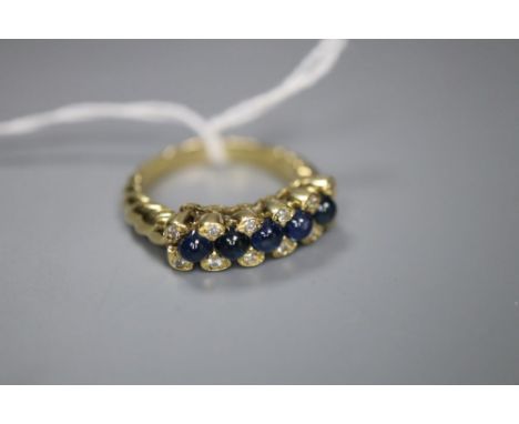 A modern 750 yellow metal, cabochon sapphire and diamond set half hoop dress ring, with spiral twist shank, size R/S, gross 8